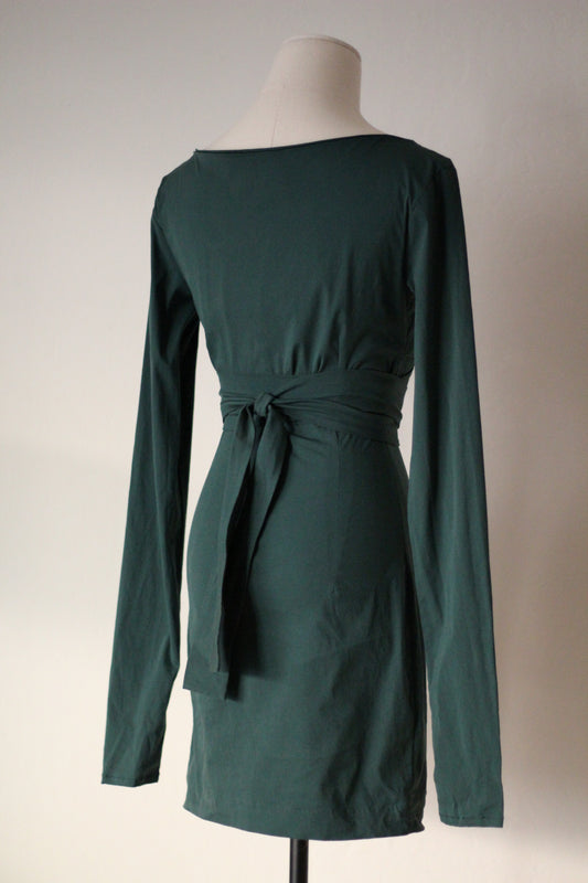 Back view of a dark green long-sleeve wrap mini dress with a tie waist and fitted silhouette, displayed on a mannequin