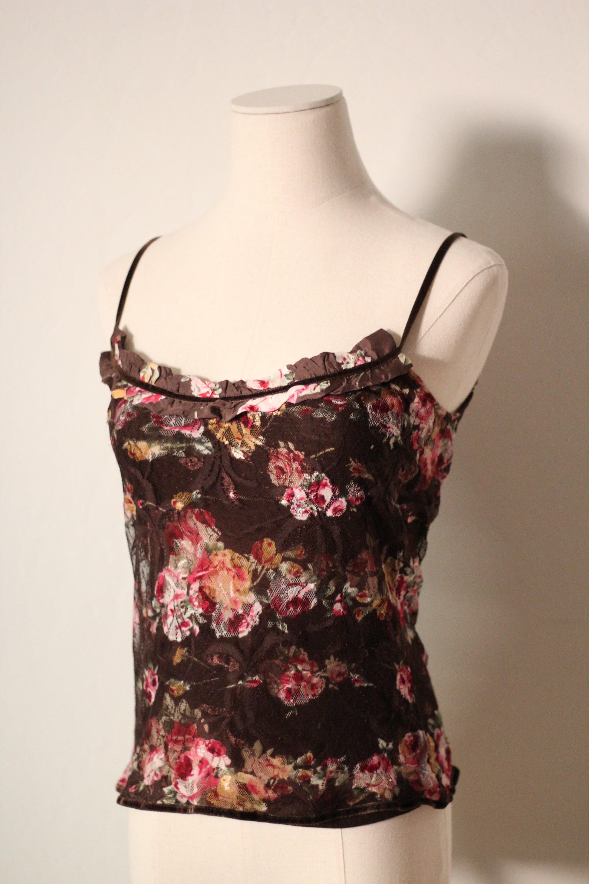 Floral top on a mannequin against a plain background