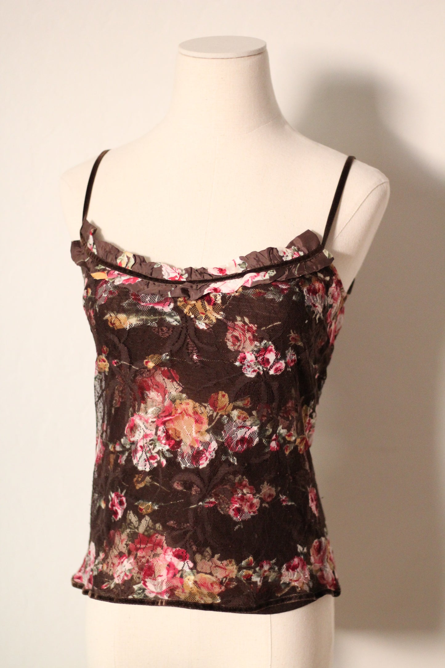 Floral top on a mannequin against a plain background