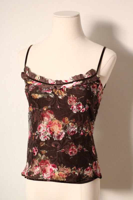 Floral top on a mannequin against a plain background