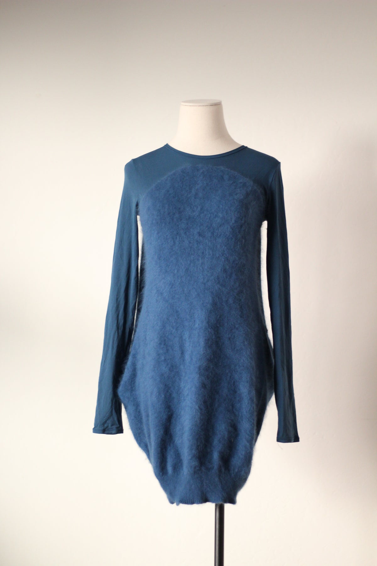 Full front view of Alexander McQueen Fall/Winter 2007 blue angora sweater dress featuring a round neckline, long fitted sleeves, fuzzy textured front panel, and rounded cocoon silhouette.