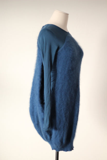 Side detail of Alexander McQueen Fall/Winter 2007 blue angora sweater dress showing the textured angora fabric, fitted long sleeve, and rounded cocoon silhouette.