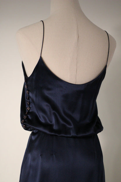 Close-up back view of the Chloé Spring/Summer 1999 navy blue silk runway dress featuring thin spaghetti straps, a low scoop back, and decorative side button detailing.