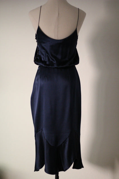 Back view of the Chloé Spring/Summer 1999 navy blue silk runway dress featuring thin spaghetti straps, a low scoop back, draped fabric, and curved seam detailing with a flared hem. 