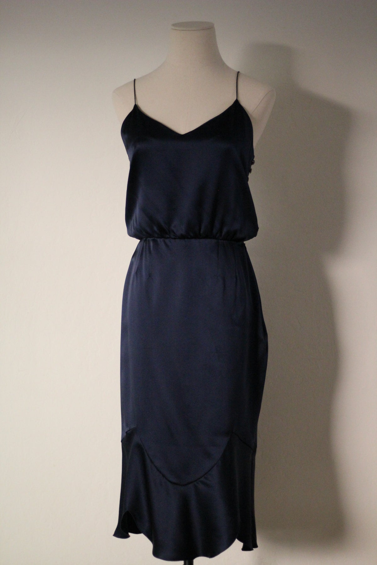 Front view of the Chloé Spring/Summer 1999 navy blue silk runway dress featuring thin spaghetti straps, a draped neckline, fitted waist, and curved seam detailing with a flared hem.