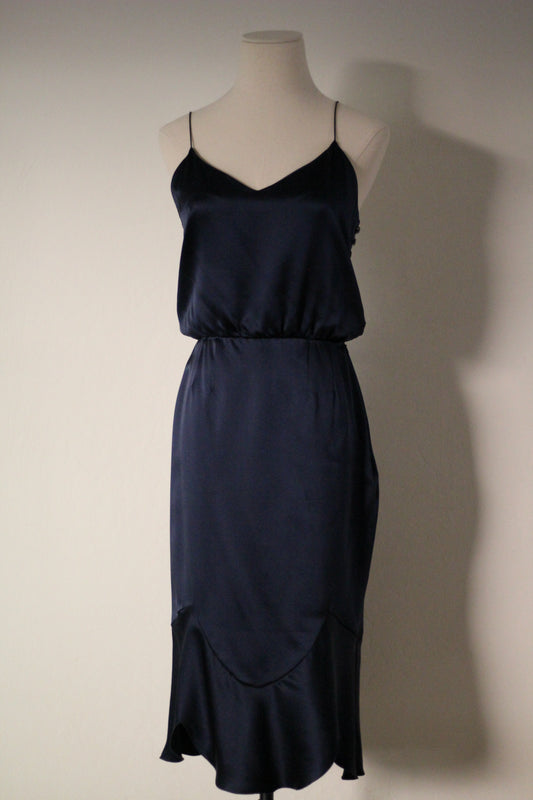 Front view of the Chloé Spring/Summer 1999 navy blue silk runway dress featuring thin spaghetti straps, a draped neckline, fitted waist, and curved seam detailing with a flared hem.