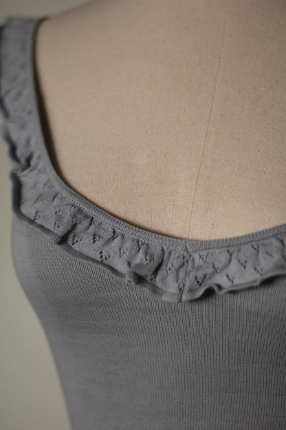 Close-up of the gray ribbed knit fabric and ruffled neckline on the Chloe by Stella McCartney 1999 tank top