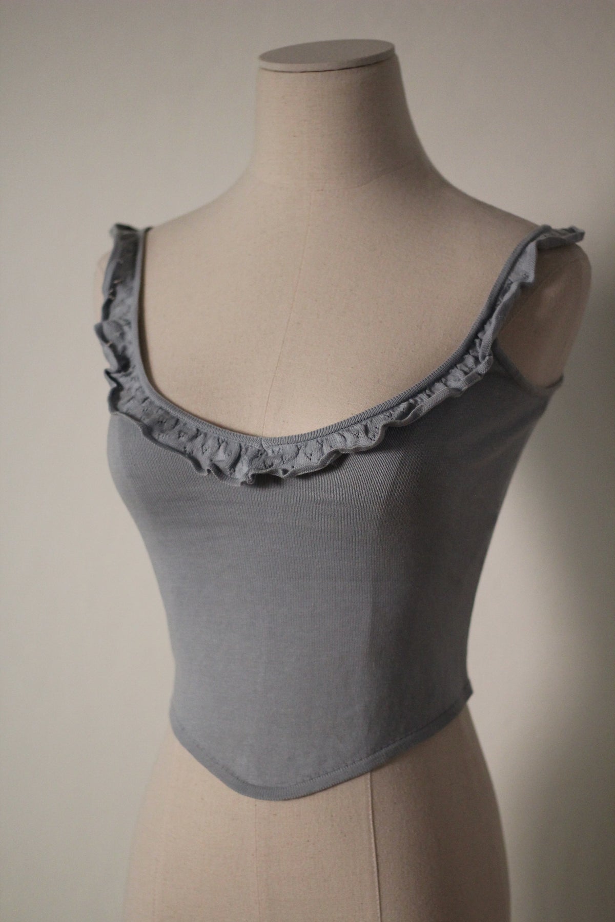 Three-quarter view of the gray Chloe by Stella McCartney S/S 1999 tank top, showing its ruffled neckline and fitted silhouette