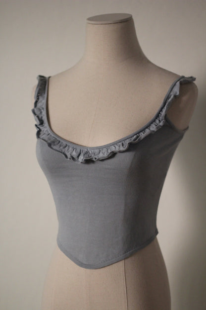 Three-quarter view of the gray Chloe by Stella McCartney S/S 1999 tank top, showing its ruffled neckline and fitted silhouette