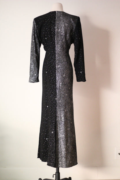 Back view of Christian Lacroix AW 1998 runway dress featuring an asymmetrical black and silver shimmering design, long sleeves, and a floor-length silhouette.