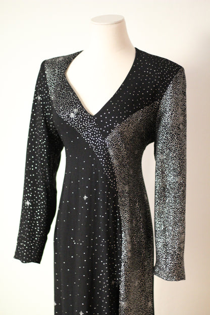 Close-up front view of Christian Lacroix AW 1998 runway dress featuring a deep V-neckline, long sleeves, and intricate silver sparkling embellishments on black fabric.