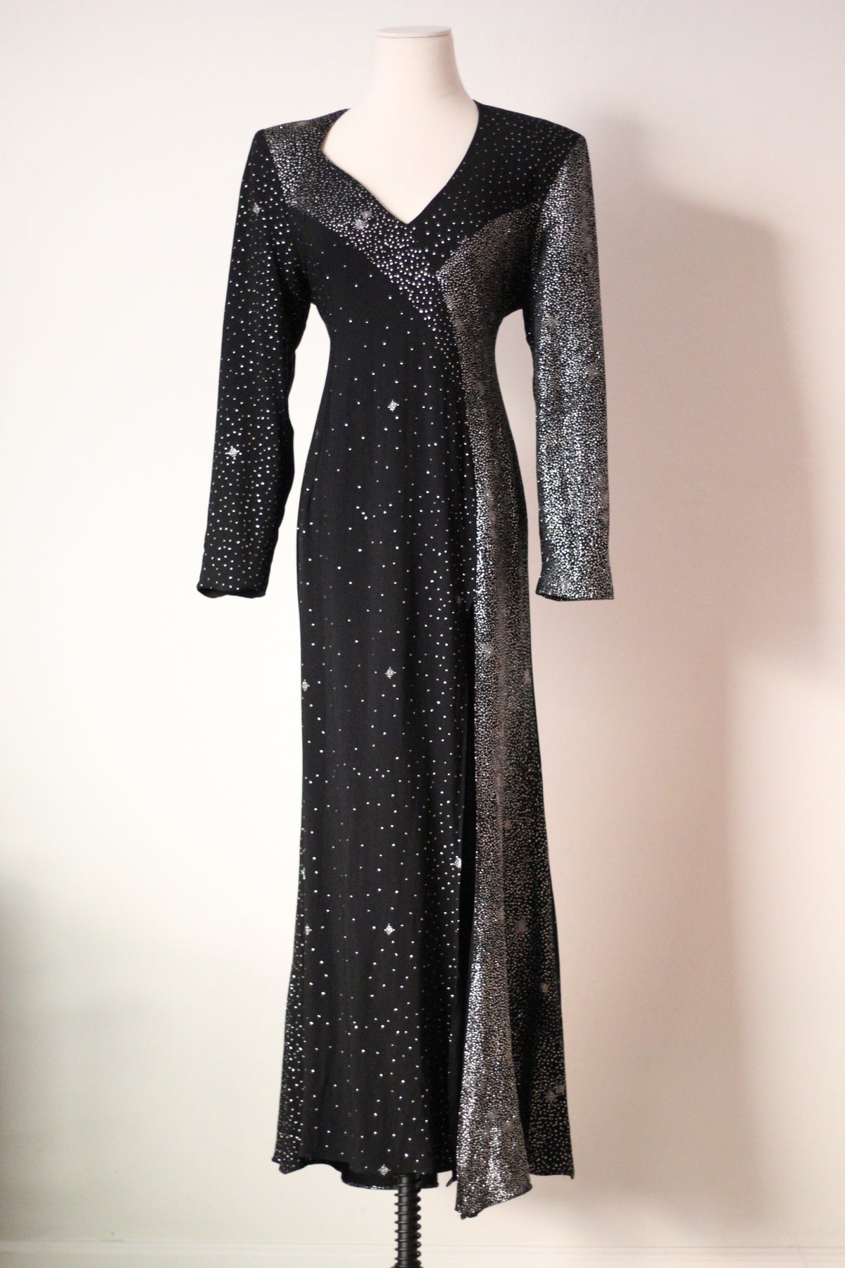 Front view of vintage Christian Lacroix AW 1998 runway dress featuring black and silver shimmering embellishments, long sleeves, a V-neckline, and a floor-length silhouette.