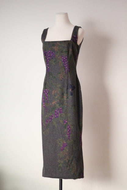 Angled front view of vintage Dolce & Gabbana Fall/Winter 1998 runway dress featuring a square neckline, fitted silhouette, and purple wisteria flowers with painted bird details on gray wool fabric.