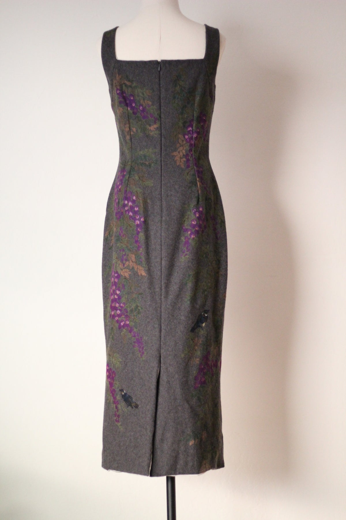 Full back view of vintage Dolce & Gabbana Fall/Winter 1998 runway dress featuring a square back neckline, center zipper, back slit, and painted purple wisteria flowers and blue birds on gray wool fabric.