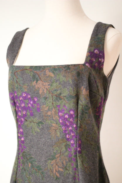 Close-up of vintage Dolce & Gabbana Fall/Winter 1998 runway dress featuring a square neckline, wide shoulder straps, and purple wisteria floral print on gray wool fabric.