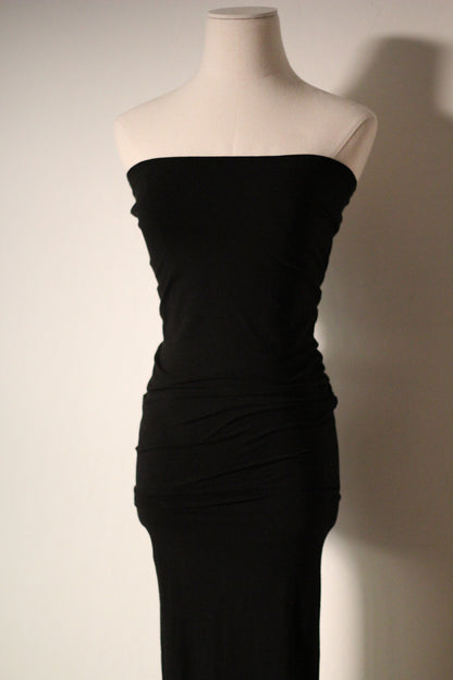 Close-up of the strapless black Dolce & Gabbana mermaid gown, showing its ruched bodice and fitted silhouette