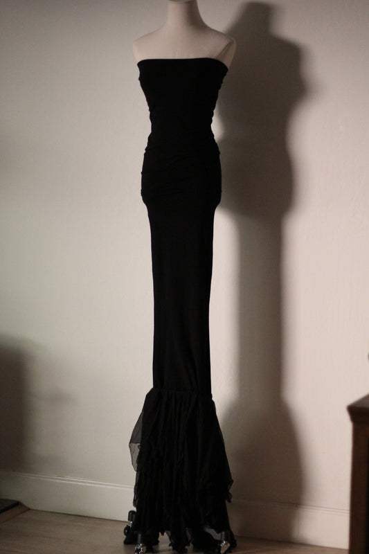 Full front view of the black Dolce & Gabbana Fall/Winter 1991 mermaid gown with a fitted silhouette and ruffled silk hem