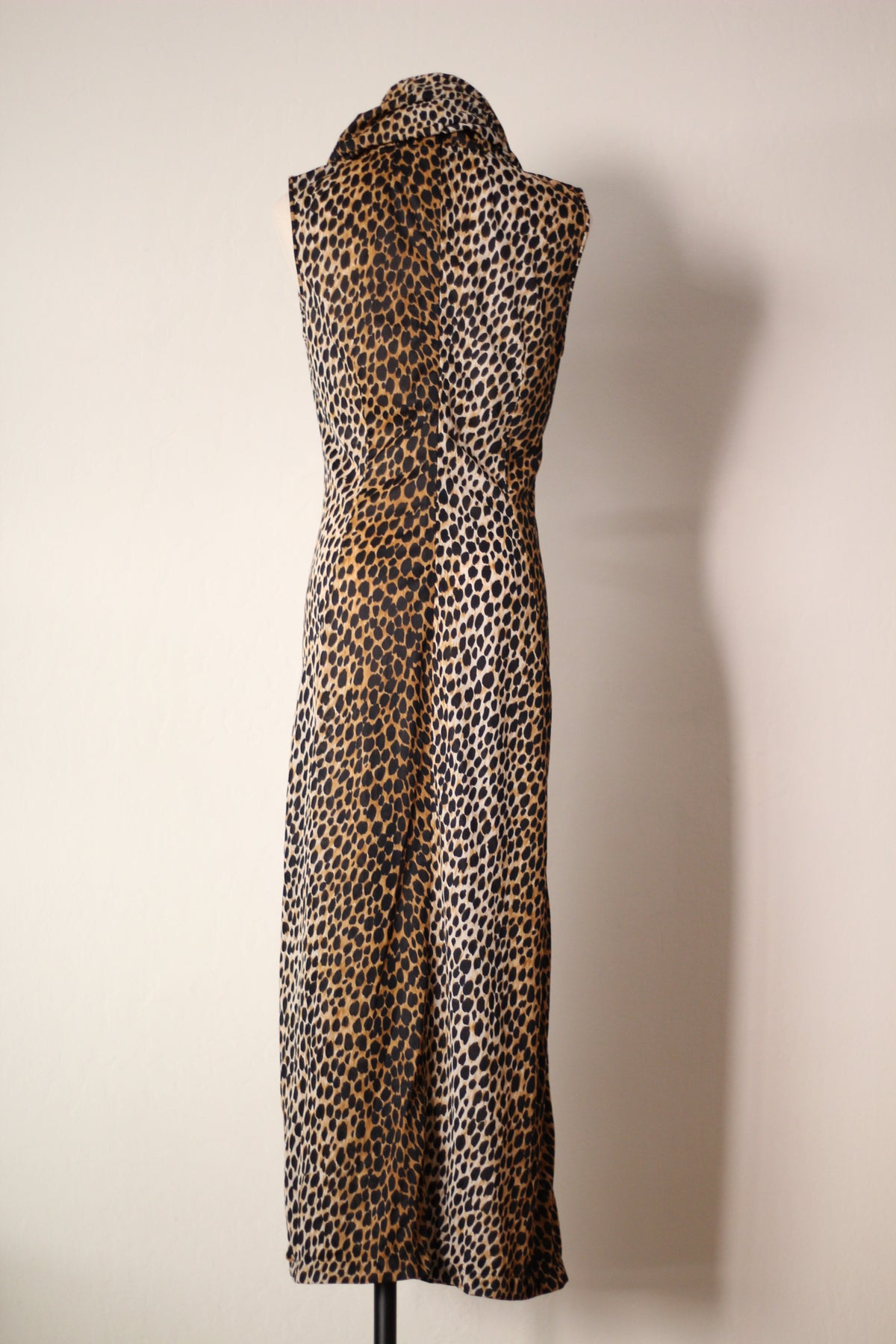 Full back view of Dolce & Gabbana Spring/Summer 1996 cheetah-print hooded runway dress featuring a sleeveless design, draped hood, fitted waist, and long silhouette with an allover animal print.