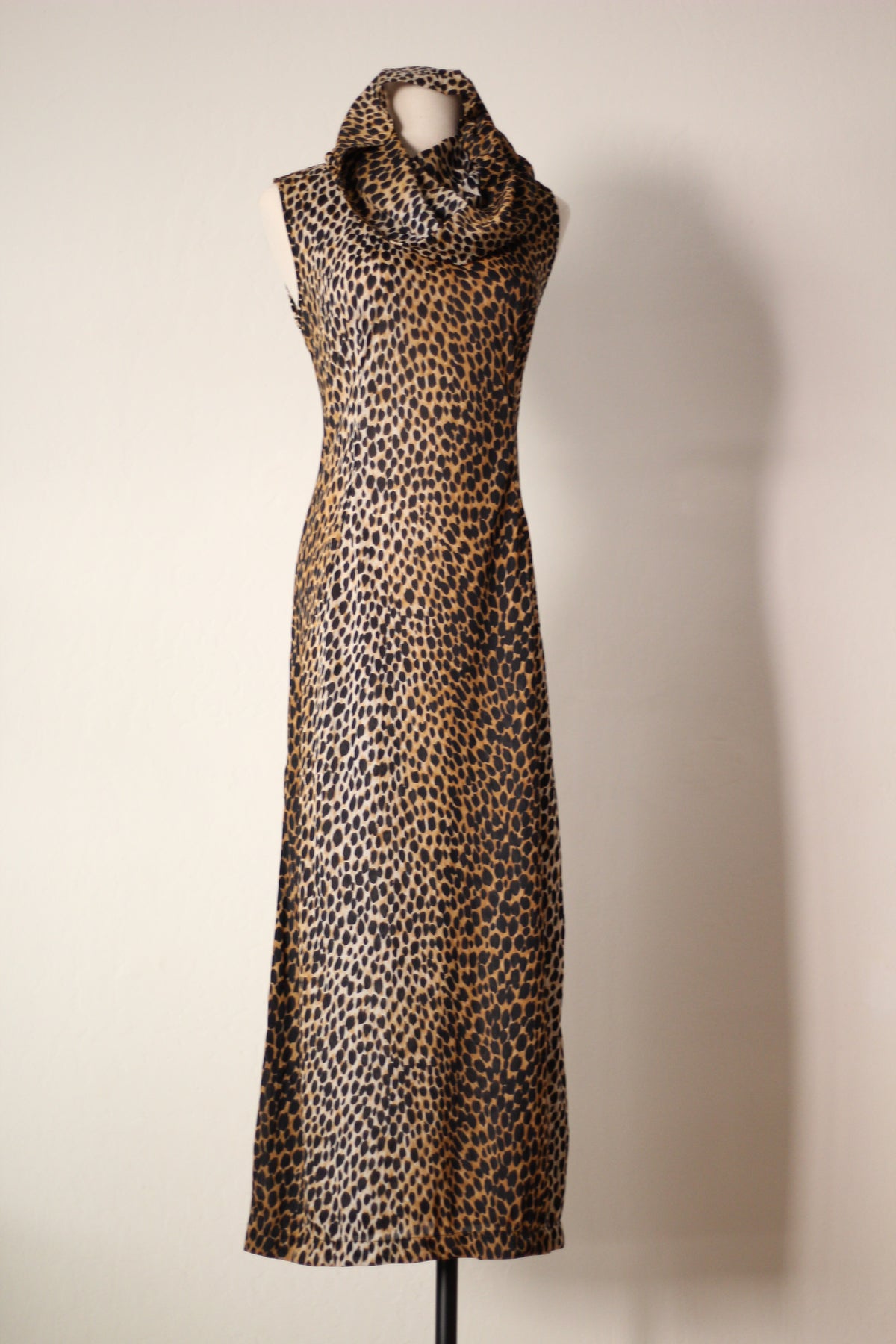 Full front view of Dolce & Gabbana Spring/Summer 1996 cheetah-print runway maxi dress featuring a draped hood, sleeveless design, fitted waist, and floor-length silhouette.