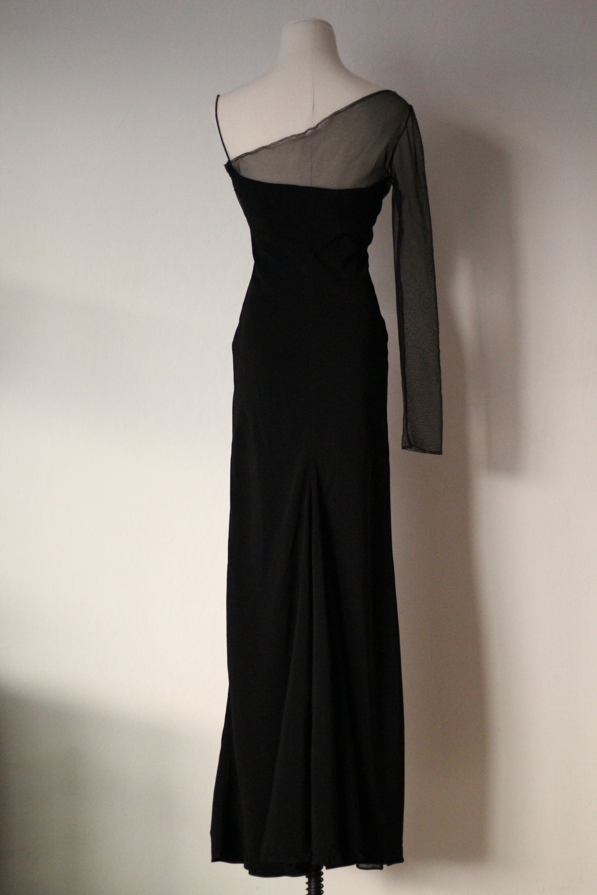 Full-length black Richard Tyler Spring/Summer 1997 gown with a one-shoulder design, sheer long sleeve, and floor-length silhouette
