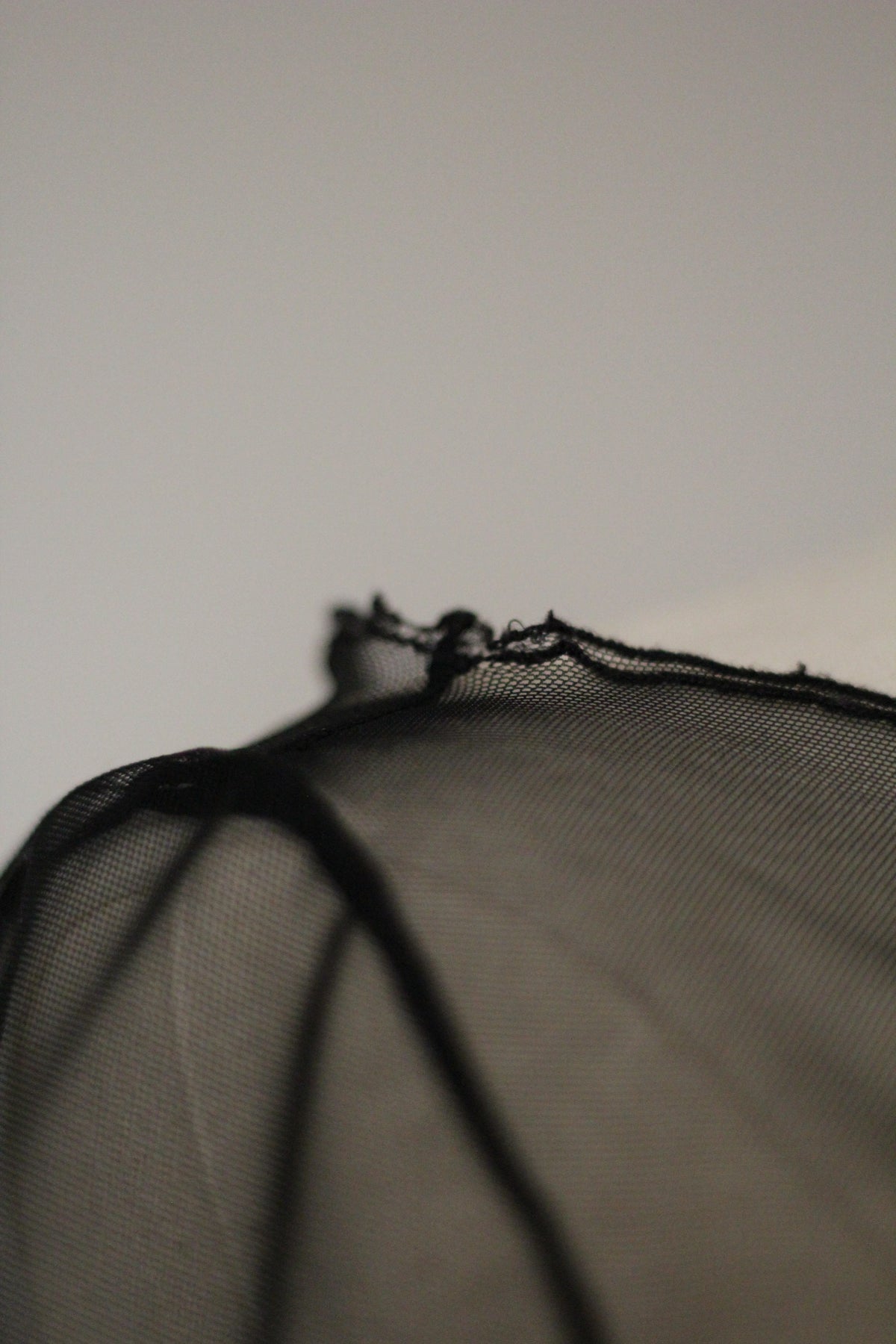 Close-up of the black sheer mesh fabric and delicate edging on a Richard Tyler Spring/Summer 1997 gown