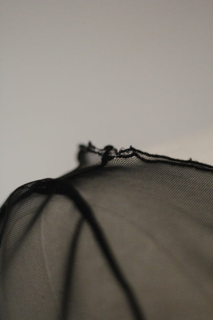 Close-up of the black sheer mesh fabric and delicate edging on a Richard Tyler Spring/Summer 1997 gown