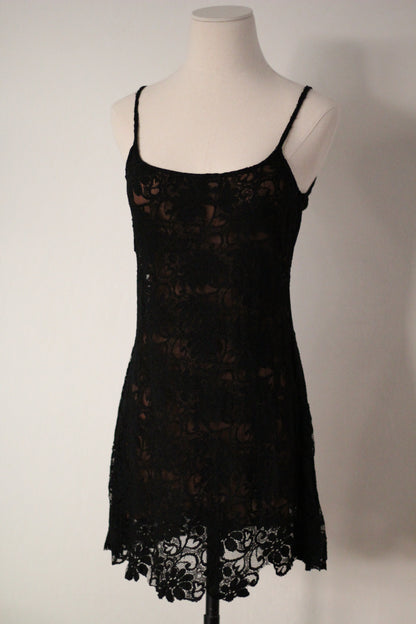 Front view of Rifat Ozbek Spring/Summer 1994 black lace runway mini dress featuring thin spaghetti straps, a square neckline, floral lace overlay, and a scalloped lace hem.