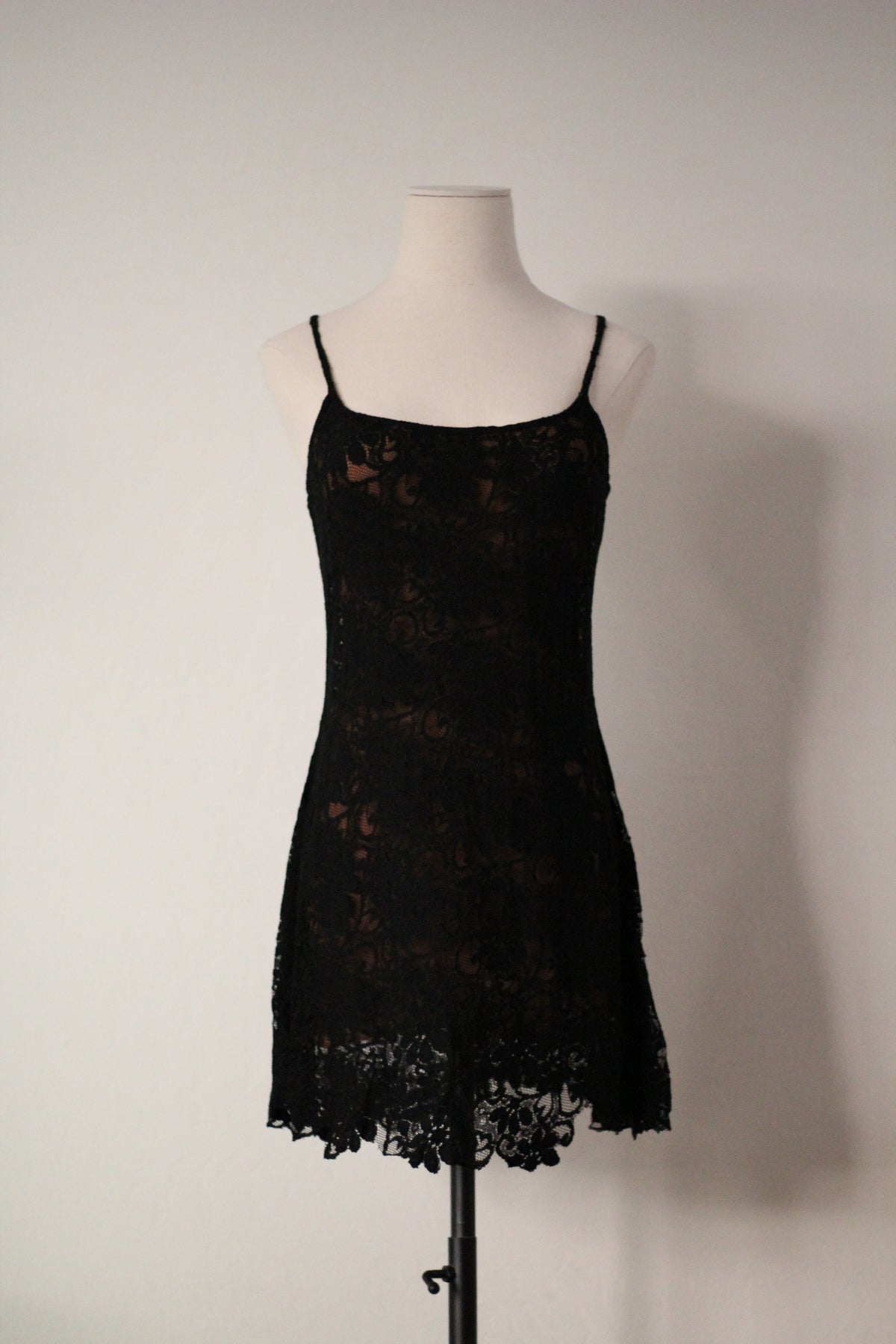 Full front view of Rifat Ozbek Spring/Summer 1994 black lace runway mini dress featuring thin spaghetti straps, a square neckline, floral lace overlay, and a scalloped lace hem.