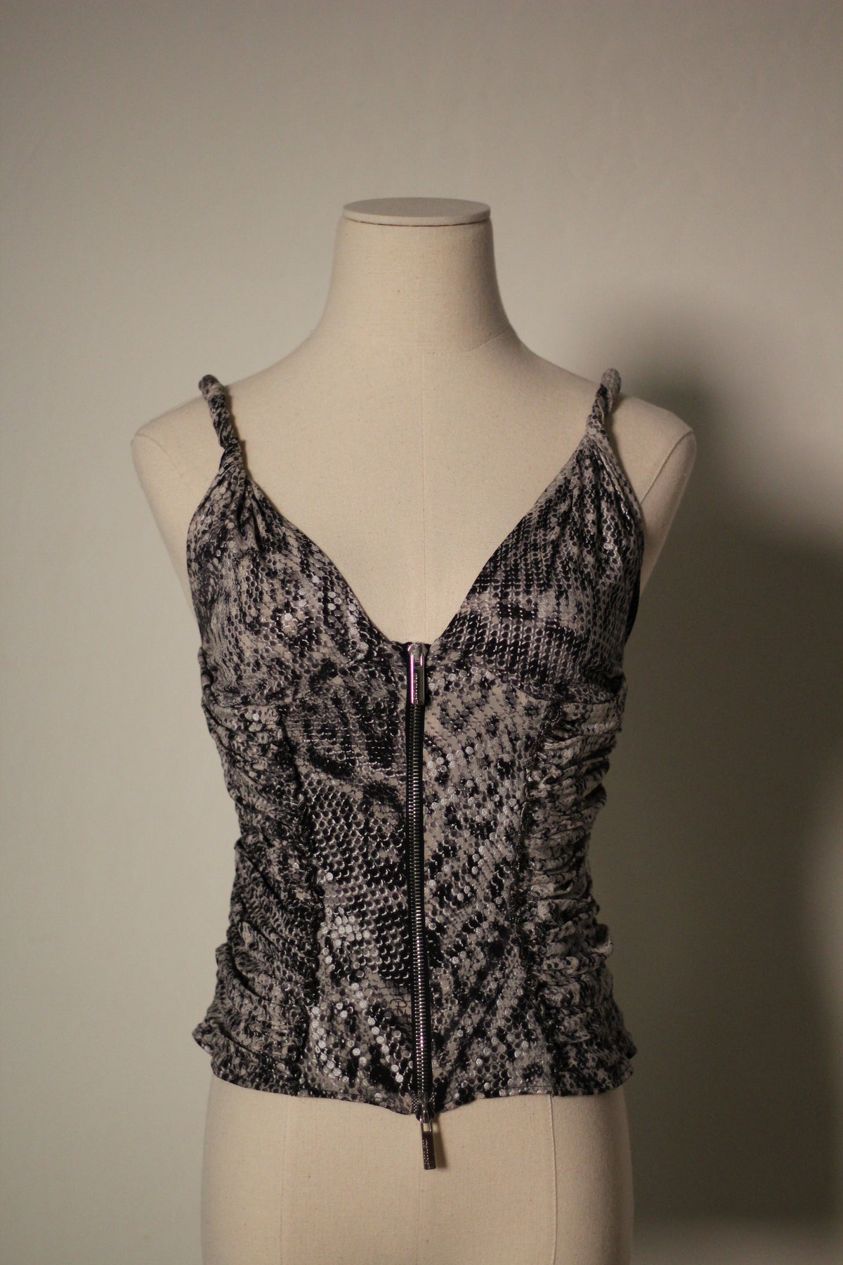 Front view of the Roberto Cavalli Fall/Winter 2003 reflective snake print top featuring a plunging V-neckline, thin straps, ruched sides, and a front zipper closure.