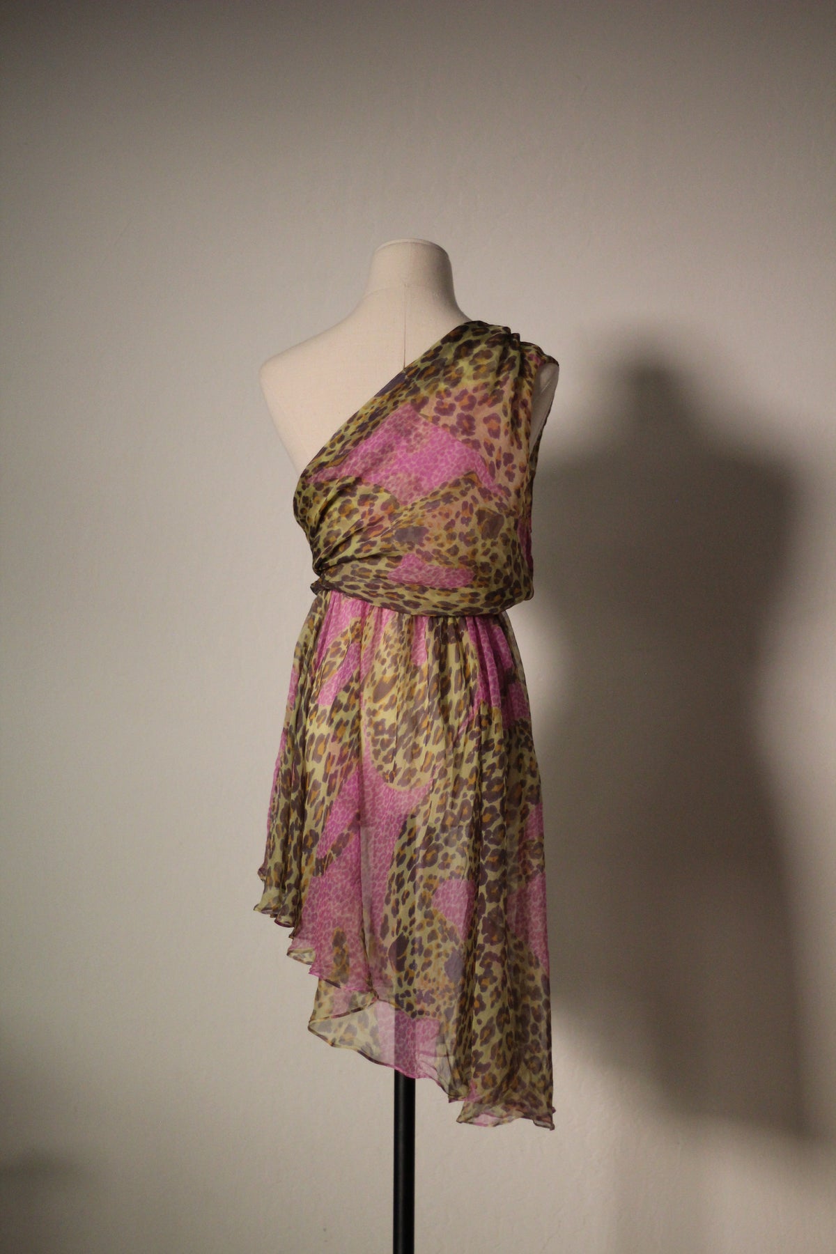 Yves Saint Laurent SS 1993 leopard print silk dress with pink and olive tones, showing the draped one-shoulder bodice and asymmetrical hem